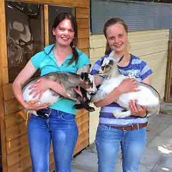 Kate and Lauren holding pygmy goats